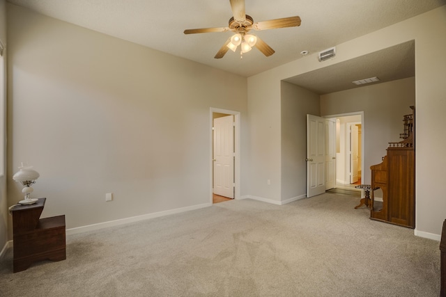 bedroom with baseboards, visible vents, ceiling fan, and light colored carpet