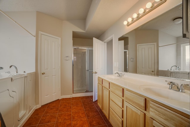 full bath with tile patterned flooring, a sink, a shower stall, and double vanity