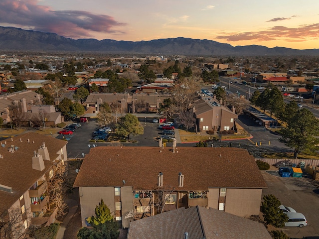 aerial view at dusk featuring a mountain view