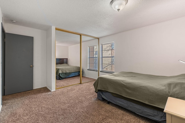 bedroom featuring carpet, a textured ceiling, and a closet