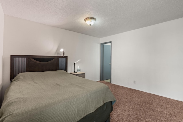 bedroom with a textured ceiling and carpet