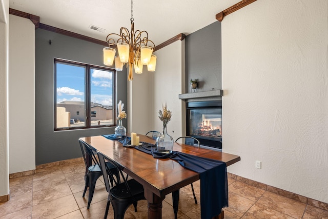 dining area with crown molding, a chandelier, and light tile patterned flooring