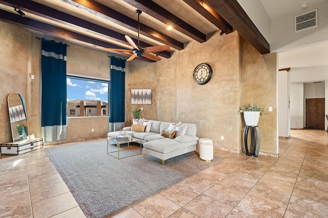 living room with ceiling fan and beam ceiling