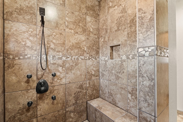 interior details featuring tiled shower