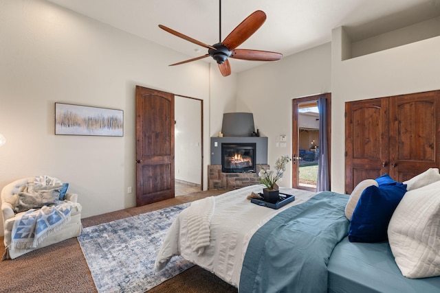 carpeted bedroom with ceiling fan and lofted ceiling