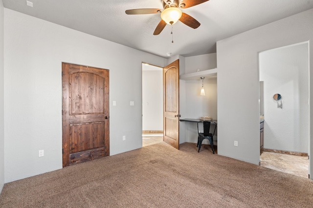 unfurnished bedroom with ceiling fan and light colored carpet