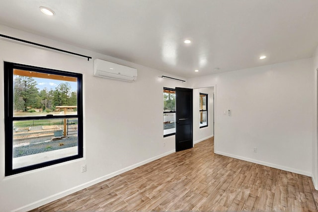 450 Juan Tomas Rd, Tijeras, NM 87059 - unfurnished room with a wall mounted air conditioner, light wood finished floors, and recessed lighting
