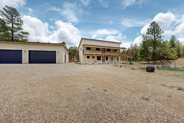 450 Juan Tomas Rd, Tijeras, NM 87059 - view of front facade with stucco siding, a detached garage, and gravel driveway