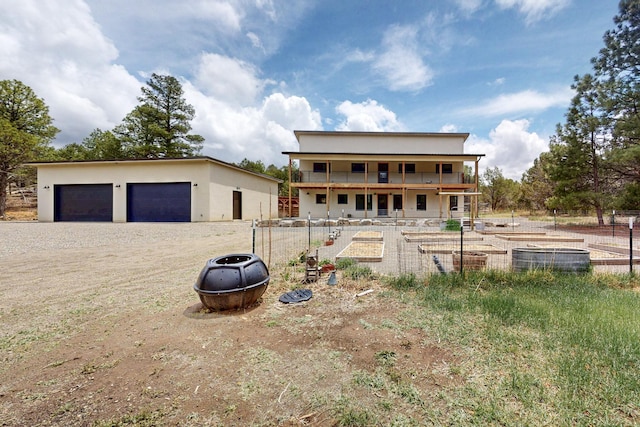 450 Juan Tomas Rd, Tijeras, NM 87059 - view of front of home featuring a garage, a garden, and an outbuilding