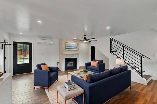 450 Juan Tomas Rd, Tijeras, NM 87059 - living room with a wall unit AC, wood finished floors, a ceiling fan, stairway, and recessed lighting