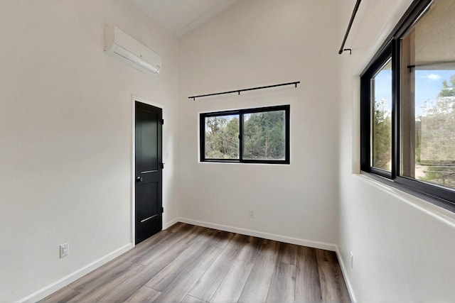 450 Juan Tomas Rd, Tijeras, NM 87059 - empty room with a wall unit AC and wood finished floors