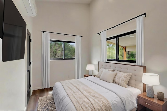 450 Juan Tomas Rd, Tijeras, NM 87059 - bedroom featuring a wall mounted air conditioner, a high ceiling, and wood finished floors