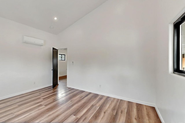 450 Juan Tomas Rd, Tijeras, NM 87059 - spare room featuring a wall mounted air conditioner, light wood finished floors, a towering ceiling, and recessed lighting