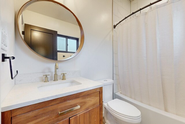 bathroom with shower / bath combination with curtain, toilet, and vanity