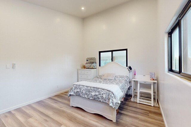 bedroom featuring recessed lighting, baseboards, and light wood-style flooring