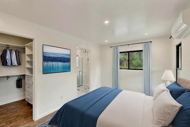 450 Juan Tomas Rd, Tijeras, NM 87059 - bedroom with a wall mounted AC, wood finished floors, a spacious closet, and recessed lighting