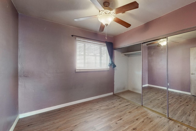 unfurnished bedroom featuring ceiling fan, hardwood / wood-style floors, and a closet