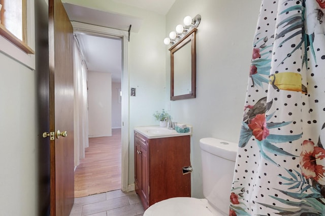 bathroom with tile patterned flooring, vanity, a shower with curtain, and toilet