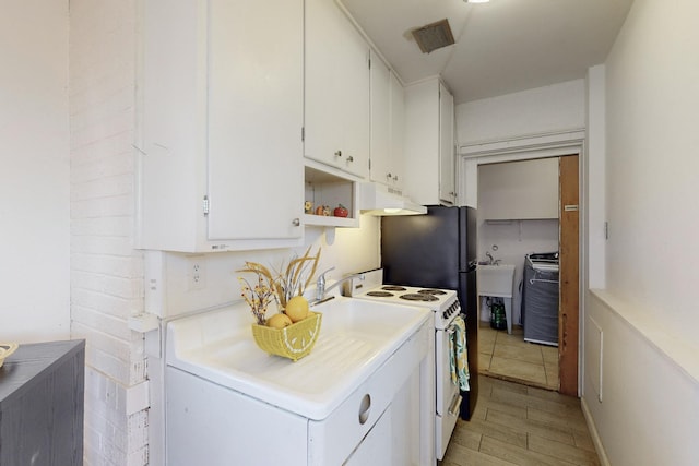 kitchen featuring white cabinetry and white electric range