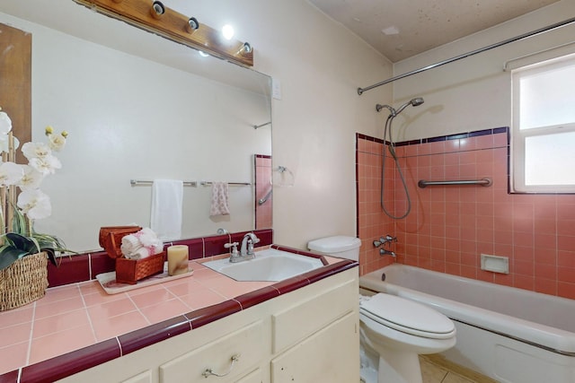 full bathroom featuring tiled shower / bath, tile patterned floors, toilet, and vanity