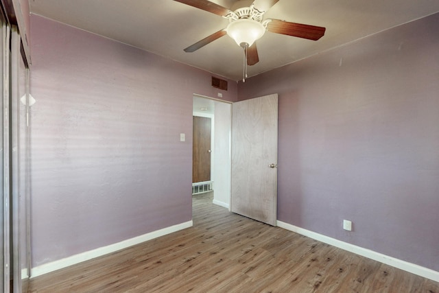 spare room featuring light hardwood / wood-style floors and ceiling fan