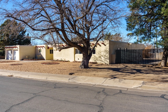 pueblo revival-style home featuring a garage