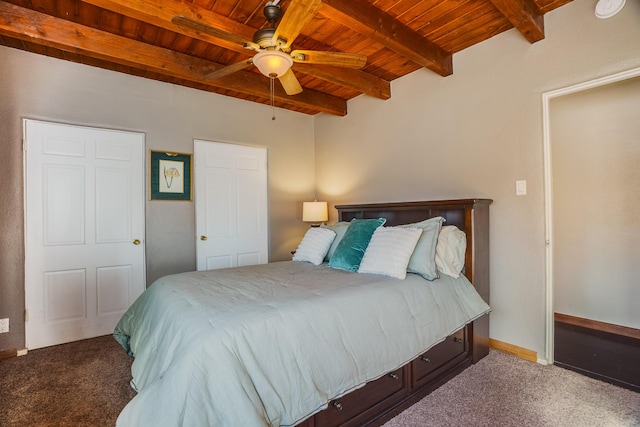 bedroom featuring beam ceiling, wooden ceiling, and carpet flooring