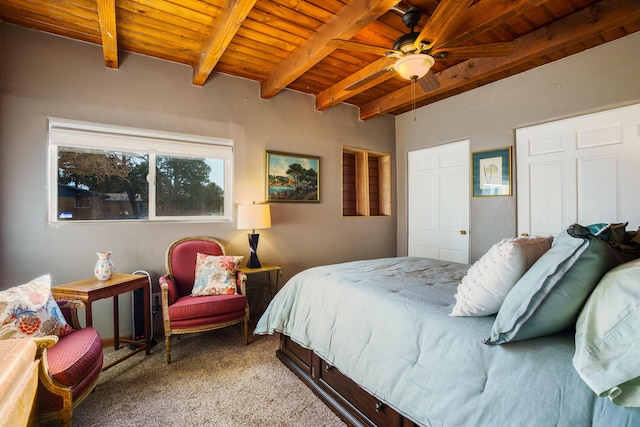 bedroom featuring beam ceiling, wooden ceiling, and carpet