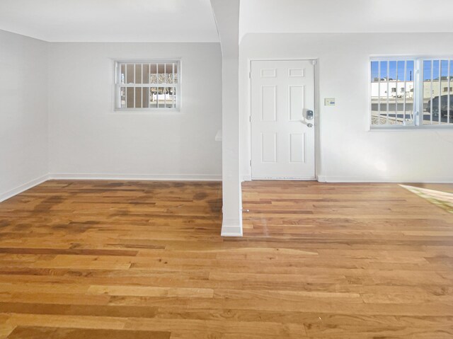 living room featuring a brick fireplace and light hardwood / wood-style flooring