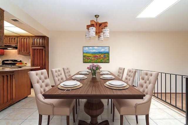 dining room featuring an inviting chandelier and light tile patterned floors