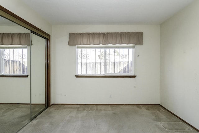 carpeted spare room featuring a healthy amount of sunlight