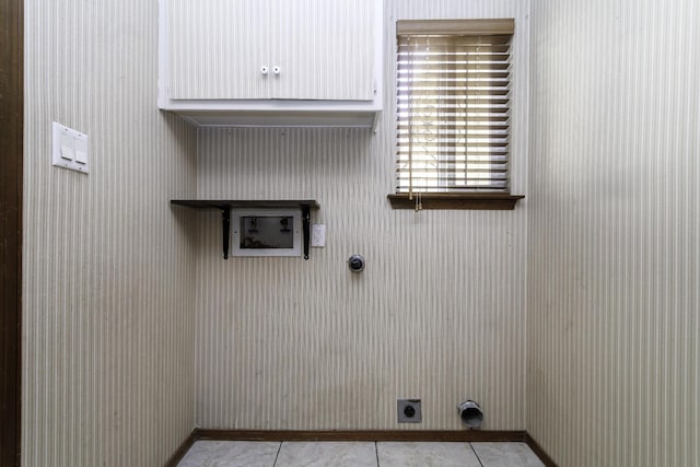 laundry room featuring cabinets, hookup for an electric dryer, hookup for a washing machine, and light tile patterned floors