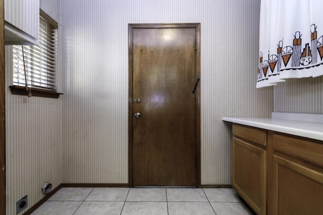 entryway with light tile patterned flooring