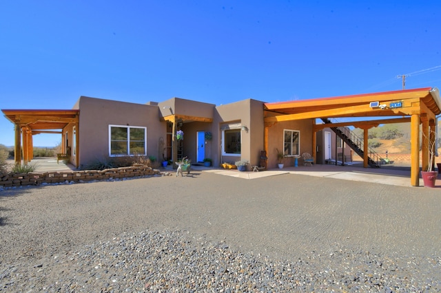 pueblo revival-style home with stucco siding