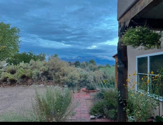 patio terrace at dusk featuring a mountain view