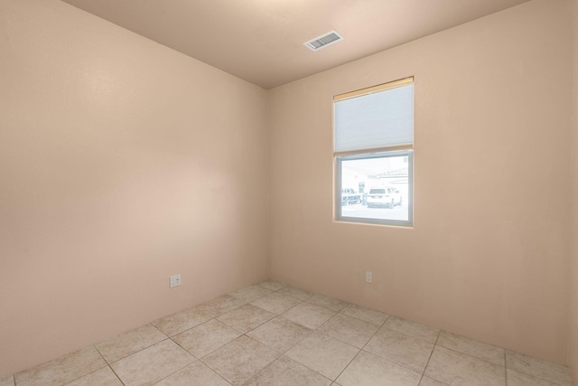 spare room with light tile patterned floors