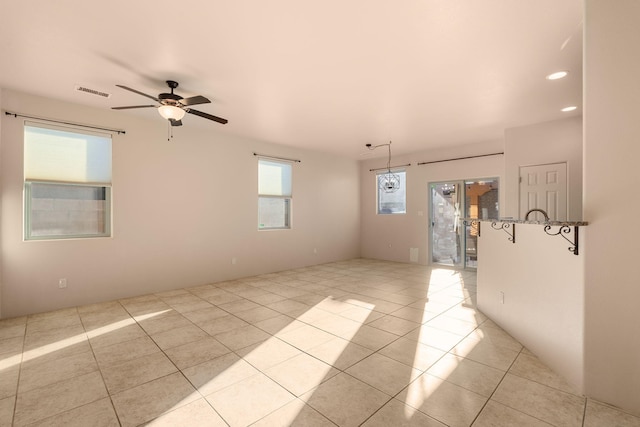 empty room with light tile patterned floors and ceiling fan