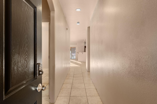 corridor featuring light tile patterned floors