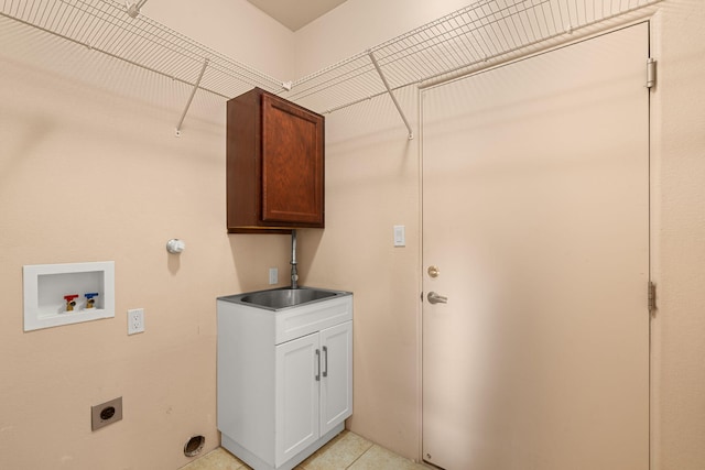 clothes washing area with light tile patterned floors, sink, electric dryer hookup, hookup for a washing machine, and cabinets