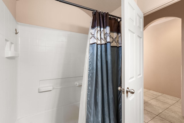 bathroom with tile patterned flooring and shower / bath combo with shower curtain