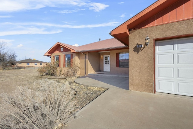 1 Blackberry Ln, Los Lunas, NM 87031 - entrance to property with a garage and stucco siding