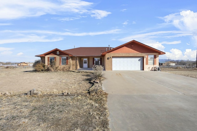 ranch-style house with a garage, driveway, and fence