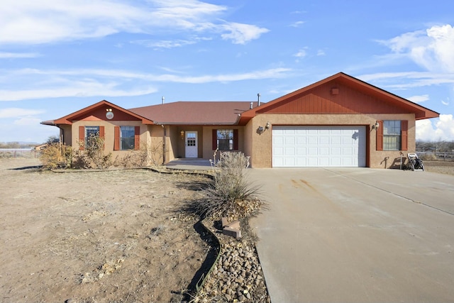 ranch-style home with stucco siding, driveway, and a garage