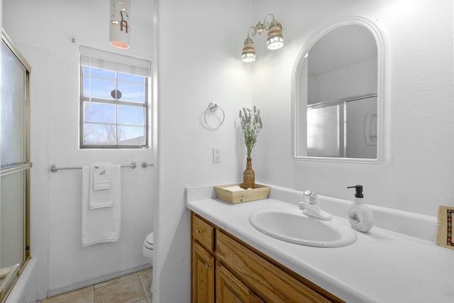 full bathroom with vanity, tile patterned floors, shower / bath combination with glass door, and toilet