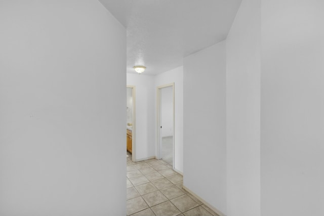 hallway featuring light tile patterned flooring