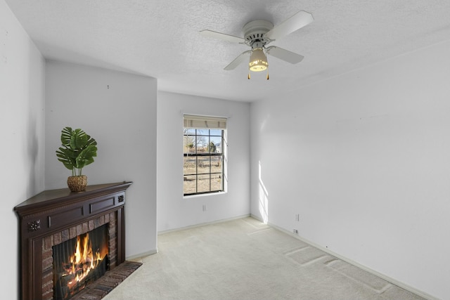 interior space with ceiling fan, a fireplace, and a textured ceiling