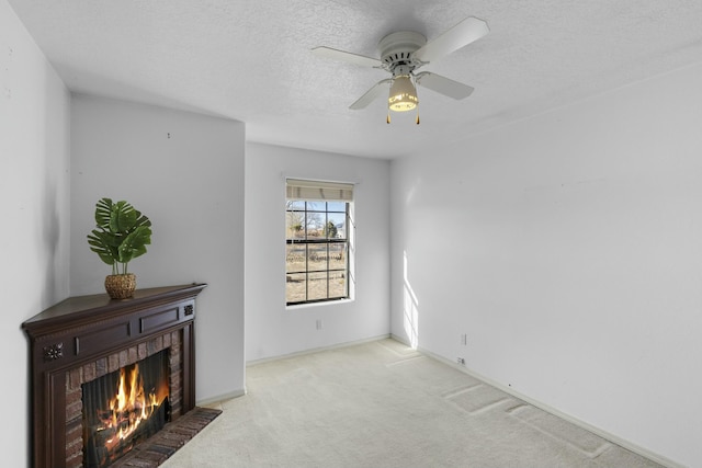 1 Blackberry Ln, Los Lunas, NM 87031 - unfurnished living room featuring carpet, a fireplace, baseboards, a ceiling fan, and a textured ceiling