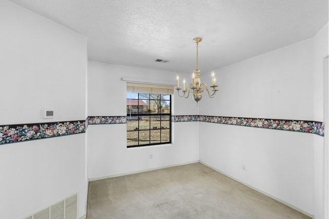 1 Blackberry Ln, Los Lunas, NM 87031 - empty room with a textured ceiling, visible vents, a chandelier, and carpet floors