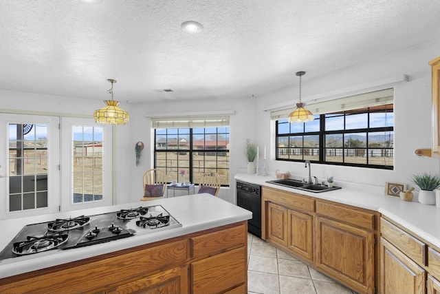 kitchen with white gas stovetop, dishwasher, sink, and pendant lighting