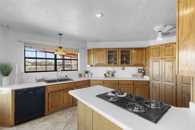 1 Blackberry Ln, Los Lunas, NM 87031 - kitchen featuring black appliances, a sink, brown cabinets, and light countertops